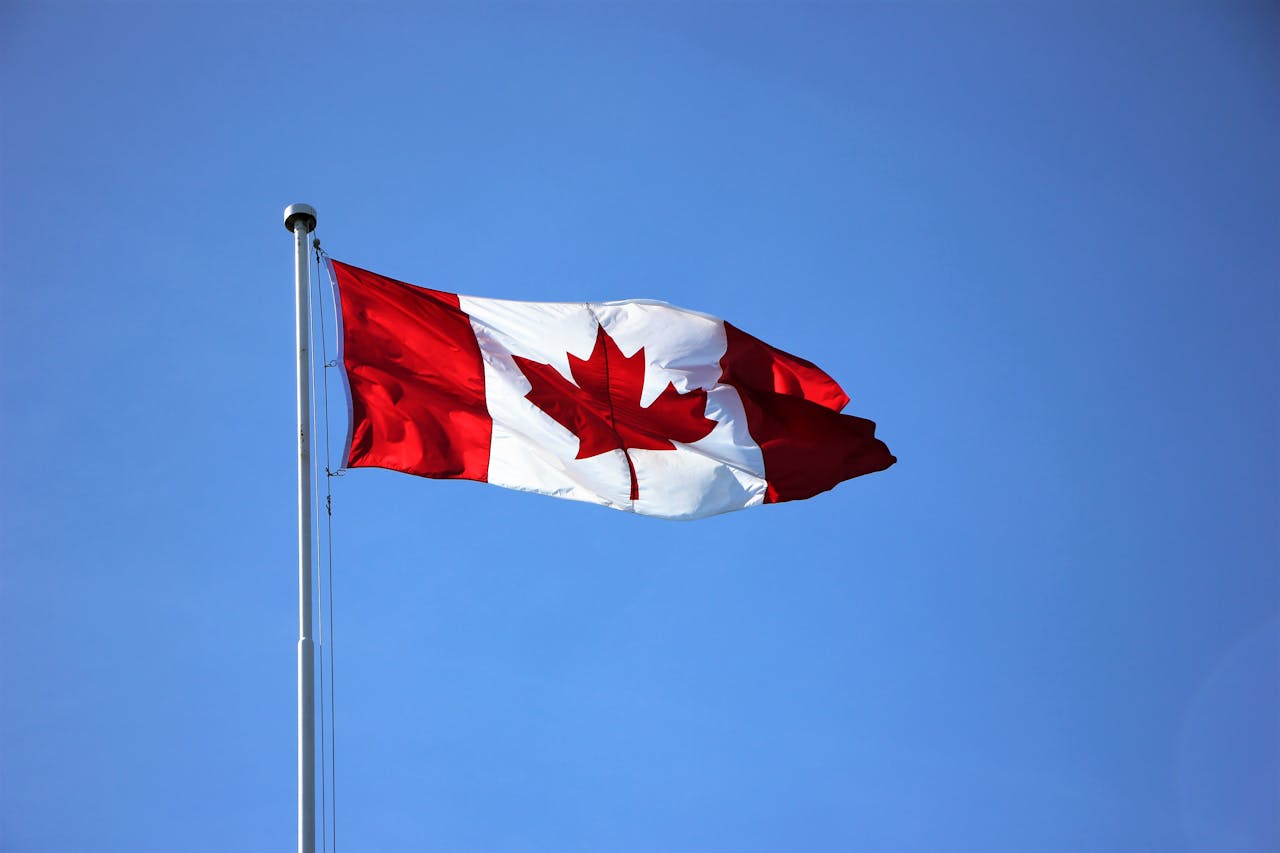 A Canadian flag in the wind on a sunny day