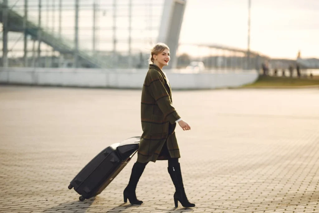 A woman traveling carrying a suitcase