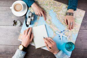 two people planning a trip over coffee while reviewing a map