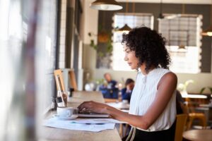 Woman sitting in a cafe while working on her laptop