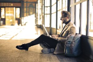 a man at the airport working on his laptop