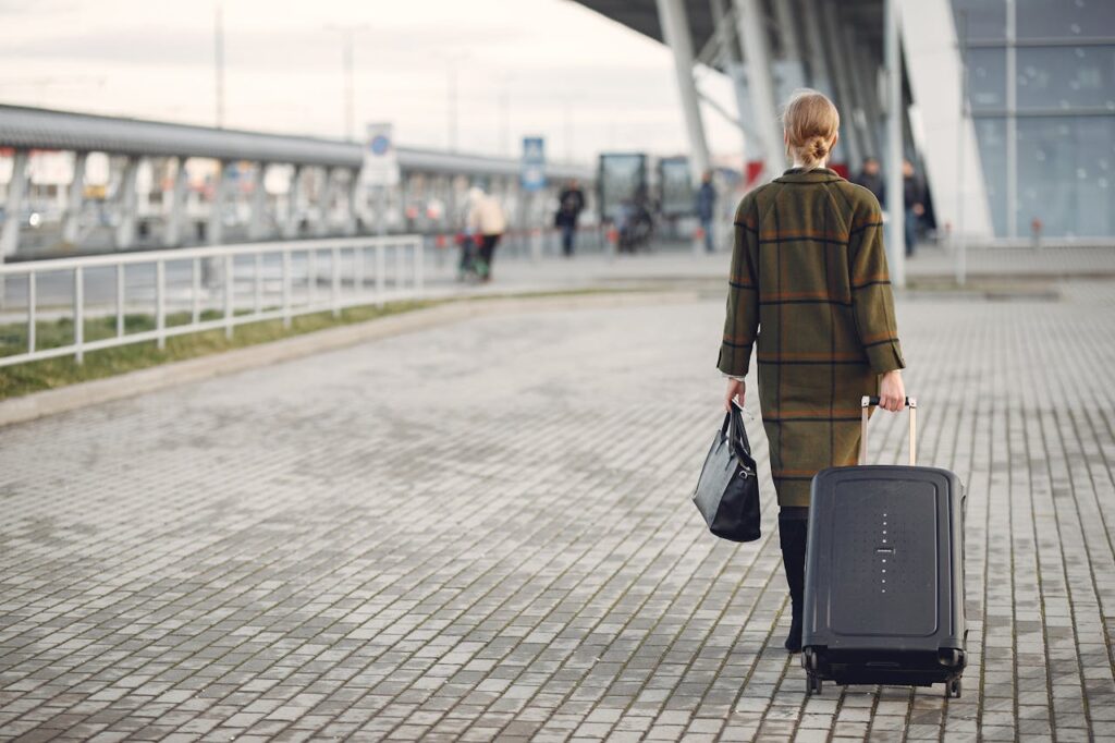 woman carrying a suitcase while travelling