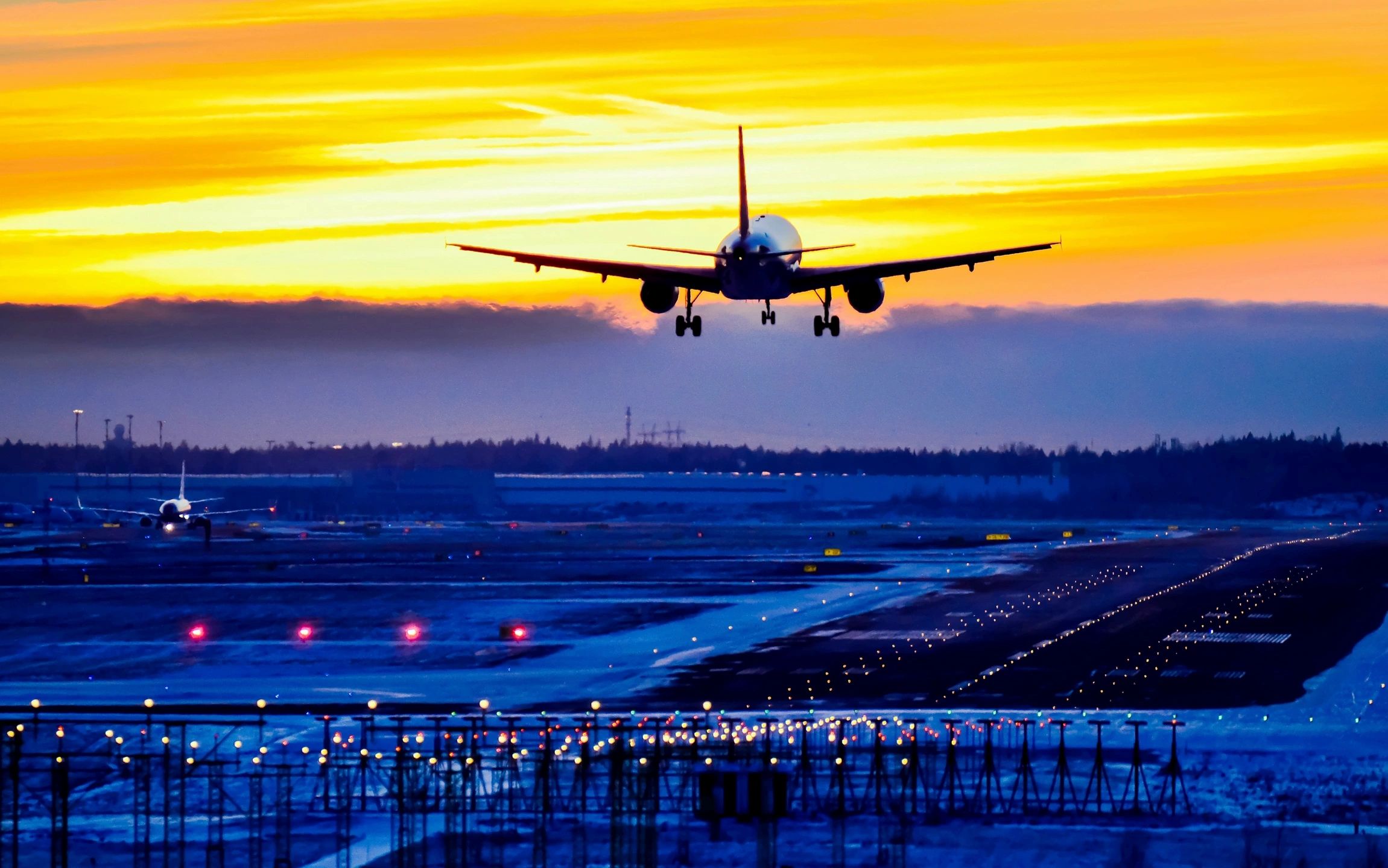an airplane landing with travellers in a corporate travel program